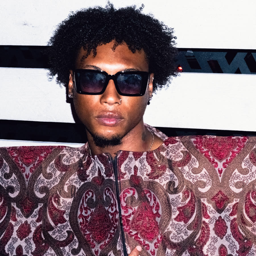 Model in sunglasses and a patterned look photographed with direct flash