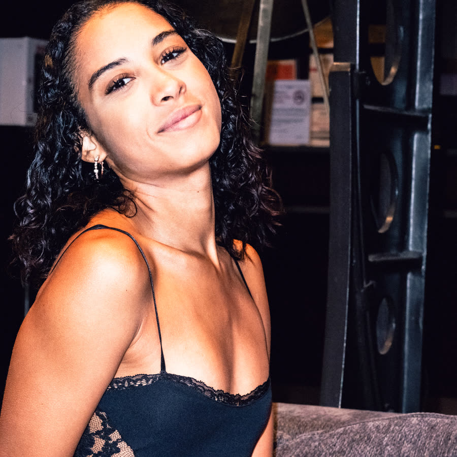 Model in a black evening look posing after dark