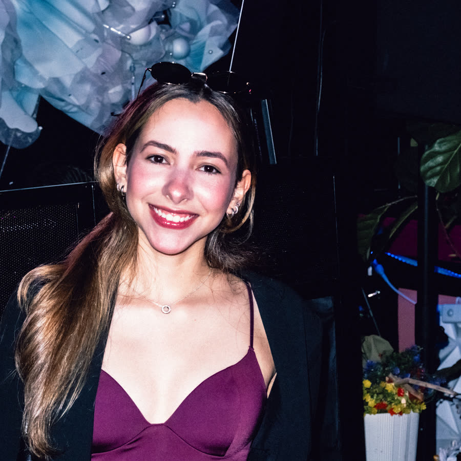 Smiling model in a burgundy evening look